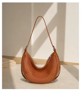 Elegant brown leather crescent shoulder bag for women, stylish underarm hobo bag.