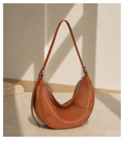 Stylish brown crescent leather shoulder bag for women, premium soft hobo underarm purse.