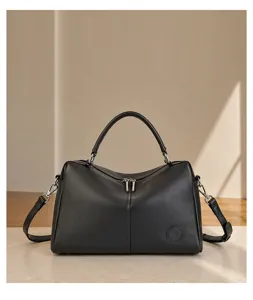 Close-up detail of premium black leather Boston handbag showcasing refined structural design.