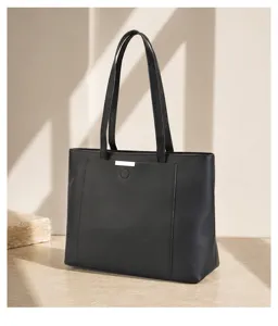 Black leather tote bag detail, spacious shoulder handbag with metal accent for daily commute.