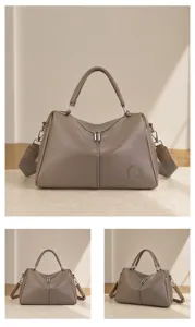 Detail view of genuine leather Boston handbag, stylish top-handle shoulder crossbody bag for women.