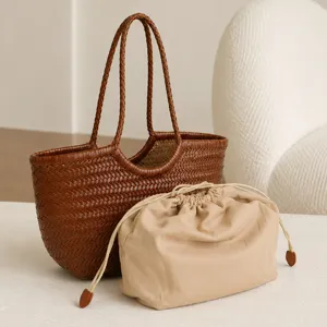 Handmade woven leather tote bag with beige drawstring pouch, French retro large capacity design.
