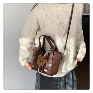 Brown women tote shoulder bag, PU leather crossbody casual commuter bag with cute bear pendant.