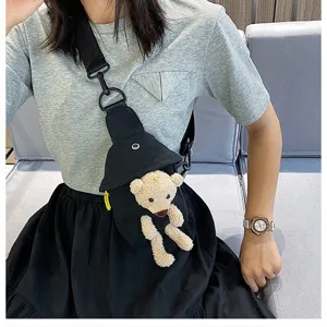 Primer plano detallado del bolso de pecho de lona negra con osito de peluche, moderno.