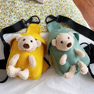 Vista detallada de bolsos cruzados de lona con ositos de peluche en colores amarillo y verde.