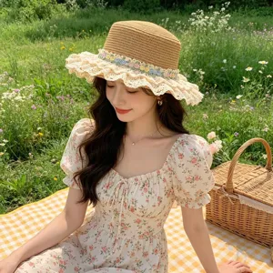 Stylish straw sun hat with delicate lace ruffles and floral embroidery for beach vacation.