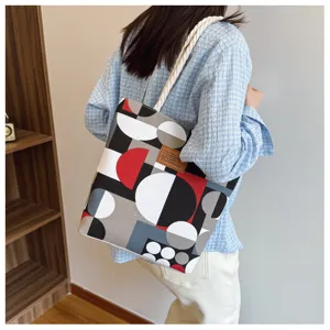 Canvas tote bag detail shot showing geometric print pattern and texture, casual daily style.