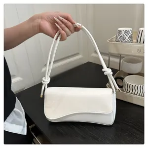White underarm shoulder bag for women, stylish chic PU leather handbag with knot handle design.
