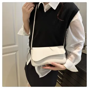 Detail shot of women white asymmetric shoulder bag, stylish casual handbag for daily wear.