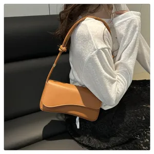 Detailed view of the stylish brown leather shoulder bag showcasing its sleek flap design.