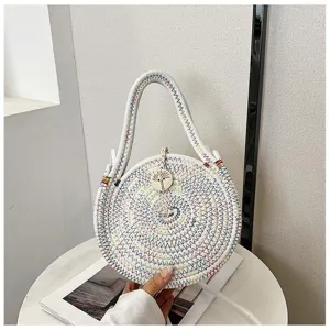 Detailed view of a round woven cotton rope crossbody bag with colorful stitching and wooden tag.