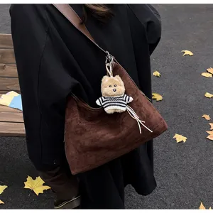 Retro brown suede slouchy shoulder bag with cute plush dog pendant for women autumn daily use.