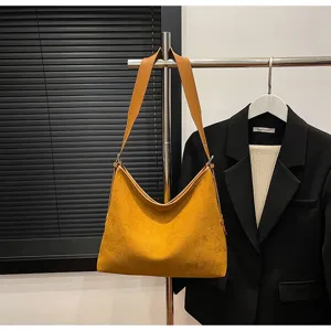 Brown suede hobo shoulder bag detailed view, showing soft texture and adjustable strap design.