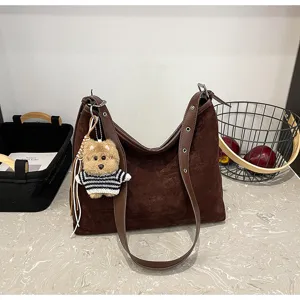 Dark brown suede shoulder bag for women, large capacity hobo bag with cute bear pendant detail.