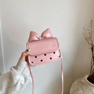 Cute pink girls crossbody bag with a big bow and polka dots, perfect daily accessory for kids.