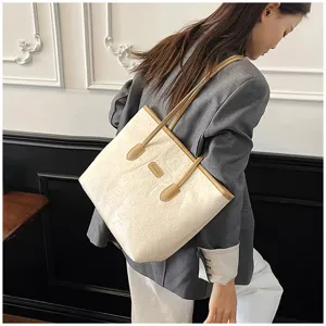 Embossed tote bag for women, stylish beige shoulder bag with brown handles, casual daily use.