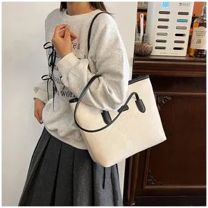 Stylish embossed tote shoulder bag for women, large capacity commuter bag detail view.