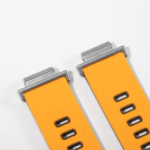Detailed view of orange rubber watch strap with metal connectors for durability and style.