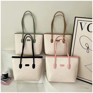 Detailed view of stylish large-capacity embossed tote shoulder bags with contrast handles.