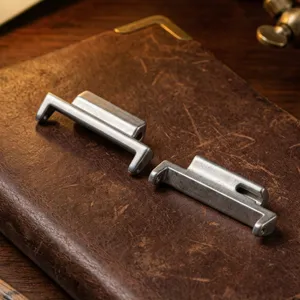 Metal watch strap adapter detail shot, retro texture surface, precision metal parts.