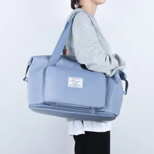 Detailed view of the front storage pocket, brand woven label, and reinforced shoulder strap.