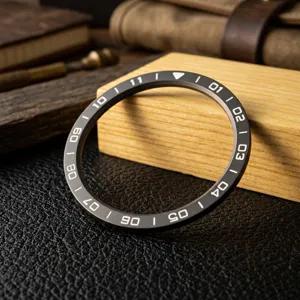 Vista dettagliata della lunetta dell'orologio nera con scale numeriche bianche precise.