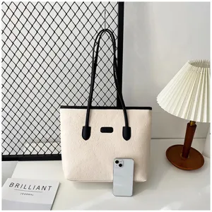 Embossed large capacity tote bag for women, stylish commuting shoulder bag with double handles.