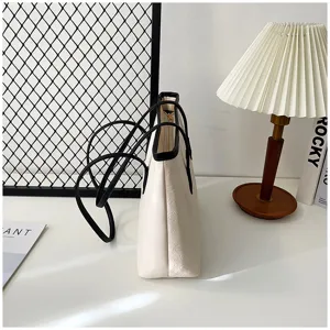 Large capacity white tote bag for women, stylish embossed design with comfortable shoulder strap.
