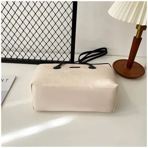 Detail view of large capacity beige embossed tote bag showing fine texture and stylish design.