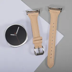 Detailed view of slim leather watch strap replacement in beige color with metallic buckle.