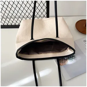 Large capacity tote bag for women, stylish embossed shoulder bag with casual design.