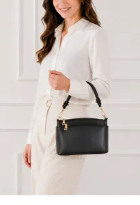 Detail view of black cowhide leather women shoulder bag, showing premium hardware and texture.