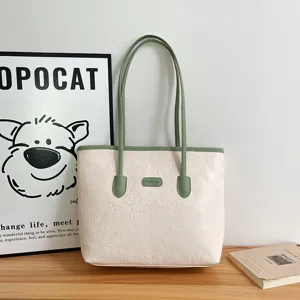 Beige large capacity tote bag for women, autumn winter casual shoulder bag with green handles.