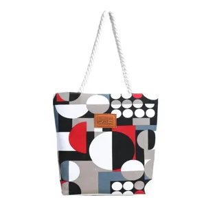 Close-up detail of canvas tote bag with geometric pattern print and white rope handle.