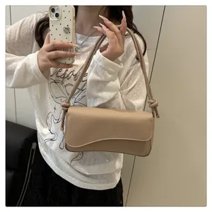 Stylish beige shoulder bag for women, chic curved flap underarm bag with knotted strap detail.