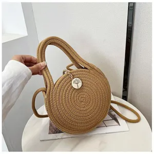 Detailed view of a bohemian round woven straw handbag, cute cotton rope shoulder crossbody bag.