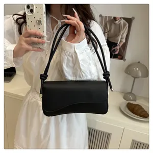 Detail shot of black PU leather shoulder bag for women, stylish underarm bag design.