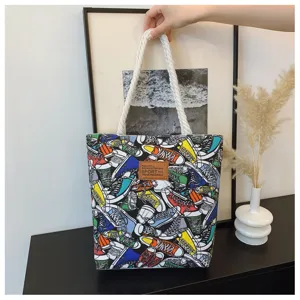 Canvas tote bag with colorful sneaker print, casual large capacity shoulder handbag for women.