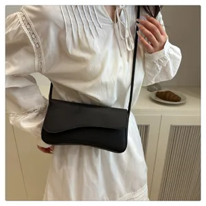 Chic black underarm shoulder bag featuring a curved silhouette for daily stylish wear.