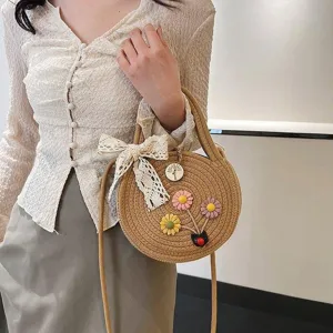 Chic pastoral style round woven straw shoulder bag with sweet lace bow and floral decor for women
