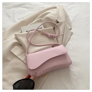 Pink leather underarm bag detail, chic shoulder strap design, elegant fashion accessory.