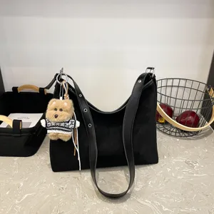 Classic black suede shoulder tote bag featuring a cute plush bear keychain for women