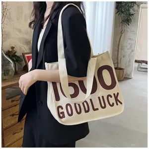 Canvas shoulder tote bag with letters print, stylish preppy style student handbag for daily use.