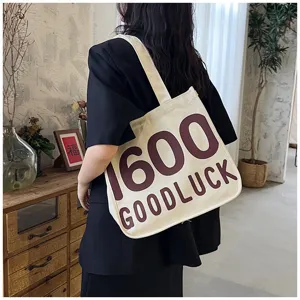 Detailed view of women canvas tote bag, casual shoulder handbag with graphic print, stylish.