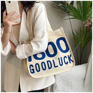 Casual canvas tote bag for women, stylish shoulder handbag with print, spacious daily shopper.