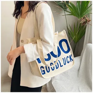 Detailed view of canvas tote bag with blue graphic print, perfect for everyday casual style.