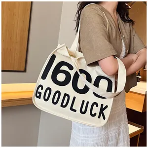 Canvas tote bag with letter print, casual single shoulder student handbag for daily use.