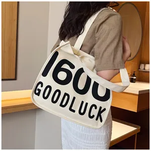 Canvas tote bag for women, casual single shoulder handbag with letter print design detail.