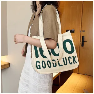 Casual canvas tote bag with green letter print, fashionable shoulder bag for daily use.