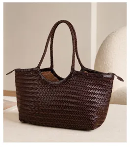 Detail view of a dark brown woven leather tote bag, premium handmade shoulder bag craftsmanship.